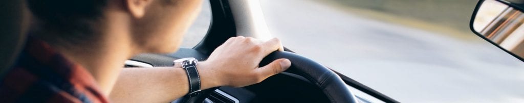 Young driver in car