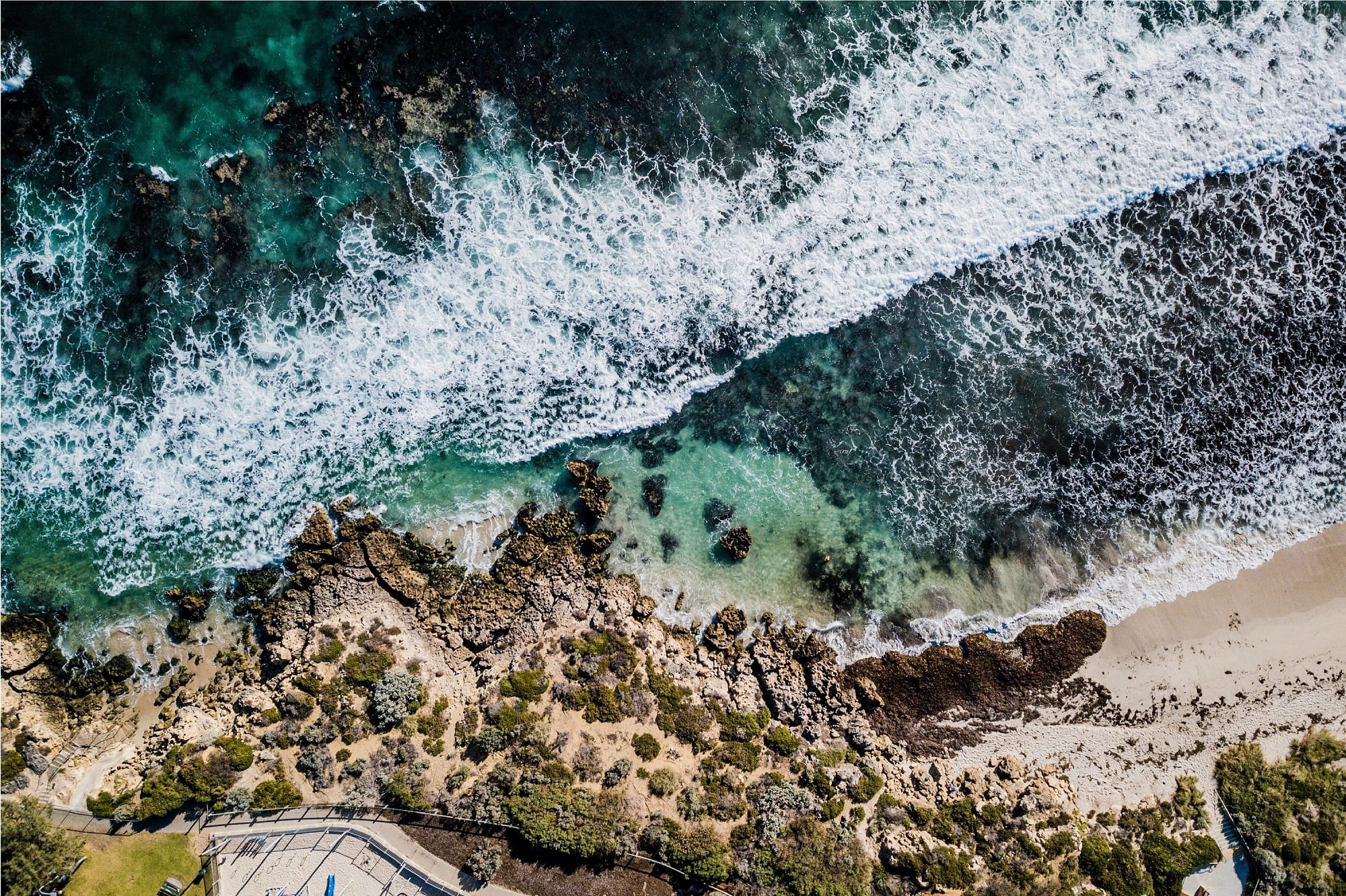 An aerial view of the sea and a road