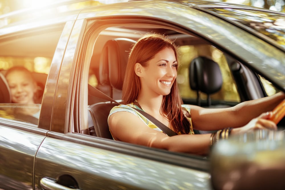 Woman driving with child