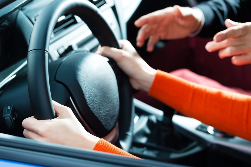 A girl holding the steering wheel