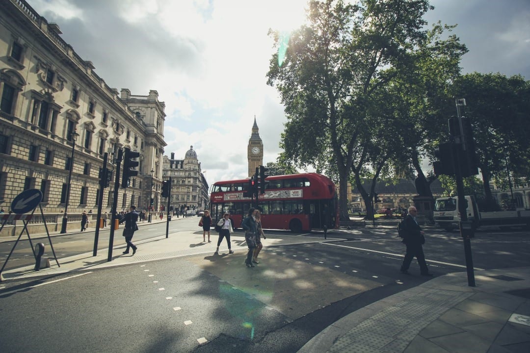 A pedestrian and cars in London