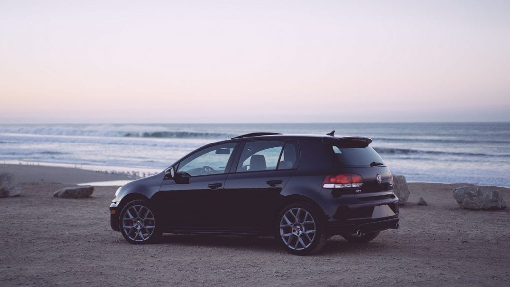 a black car by the sea