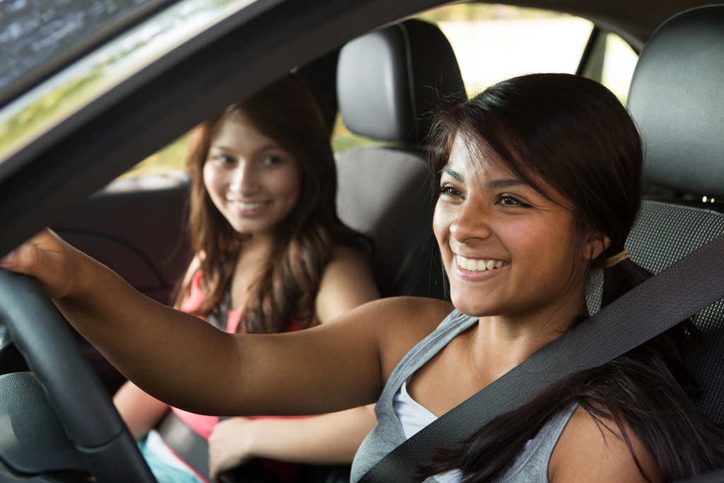 Learner driver smiling in a car