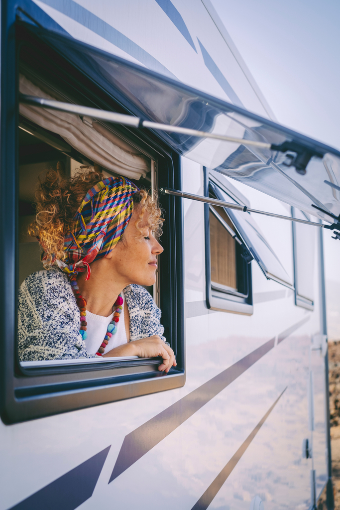 Woman looking out of a motorhome window