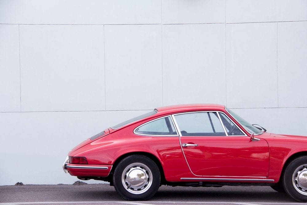 A red car against a white wall