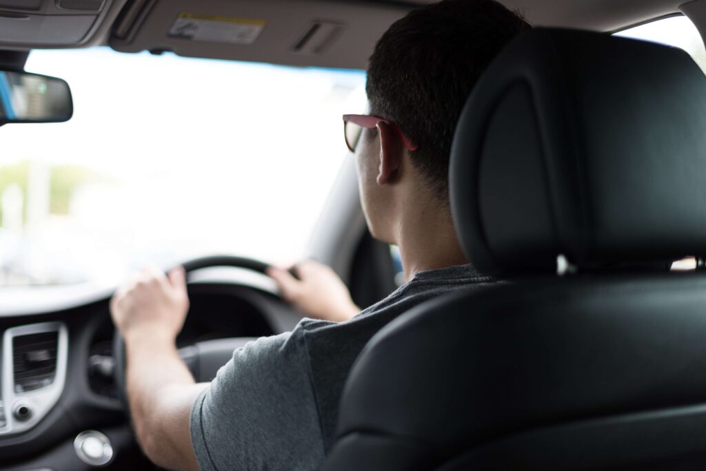teenage boy driving a car
