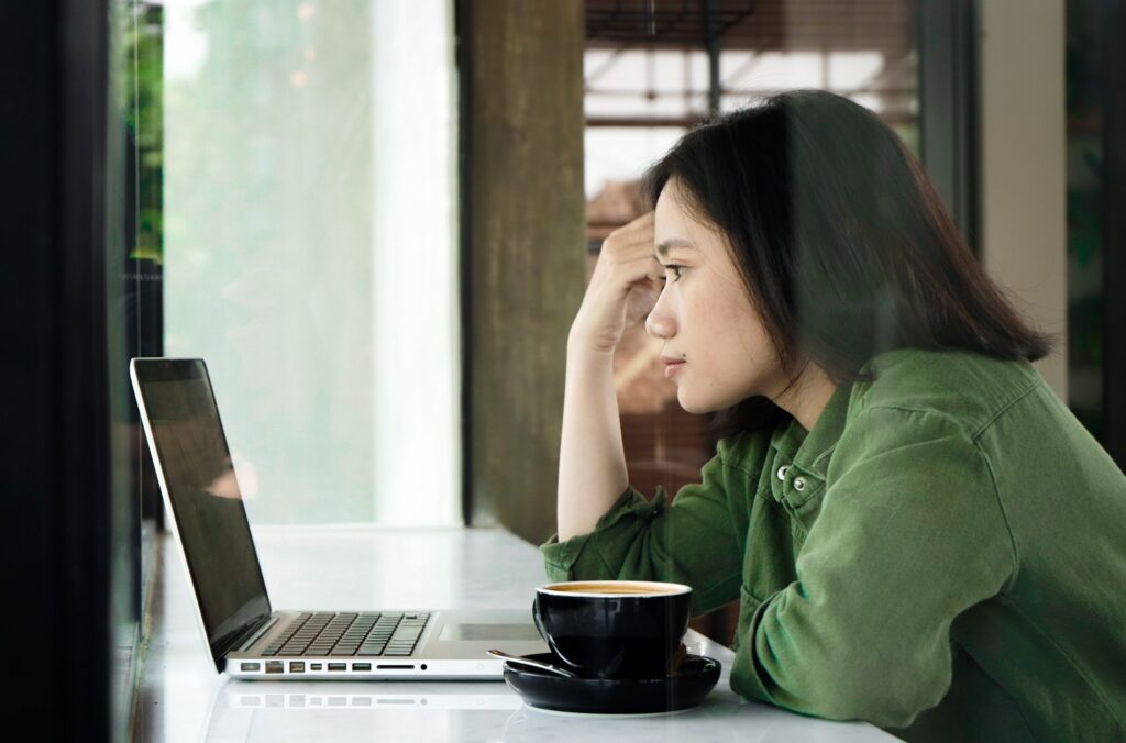 Woman staring at laptop
