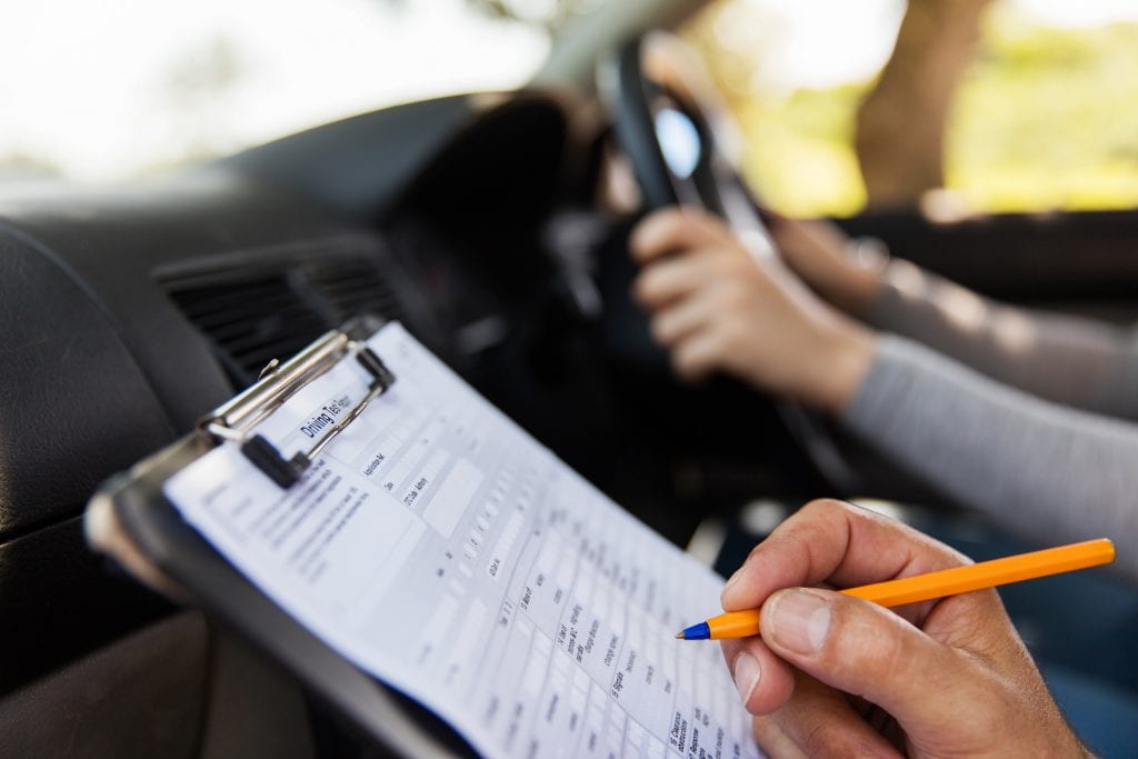 Person taking driving test in their own car