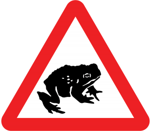 Migratory toads crossing road sign