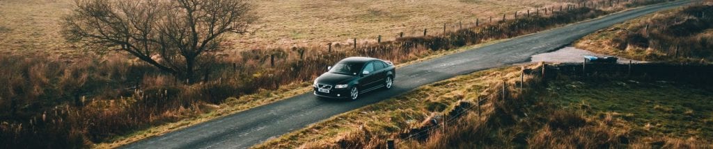 Car driving through British countryside
